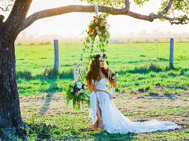 bride in a boho chair at a whitsundays wedding shoot 